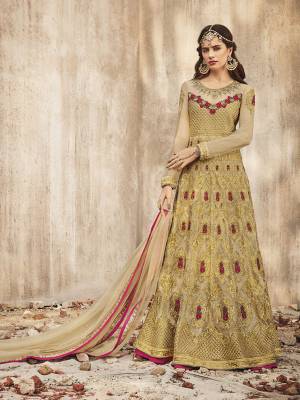 Flaunt Your Rich and Elegant Taste Wearing This Designer Anarkali Suit In Beige Color. Its Heavy Embroidered Floor Length Top Is Fabricated on Net Paired With Santoon Bottom And Net Fabricated Dupatta. Buy Now.