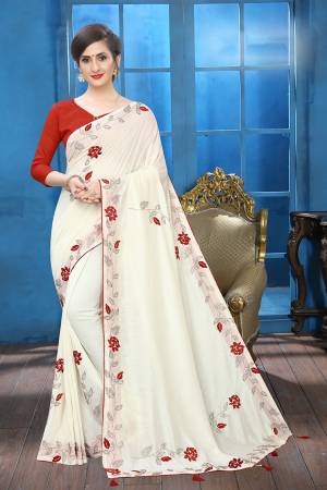 Flaunt Your Rich And Elegant Taste Wearing This Lovely Designer Saree In White Color Paired With Red Colored Blouse. This Saree And Blouse Are Silk Based Beautified With Velvet Rose Patch Work And Attractive Stone Work. Buy This Rich and Elegant Looking Saree For The Upcoming Festive And Wedding Season.