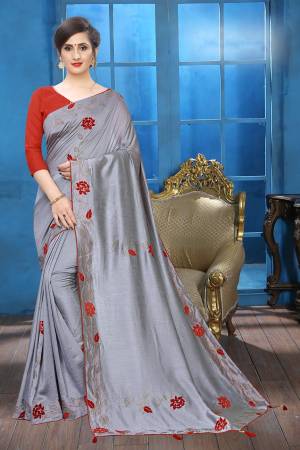 Flaunt Your Rich And Elegant Taste Wearing This Lovely Designer Saree In Grey Color Paired With Red Colored Blouse. This Saree And Blouse Are Silk Based Beautified With Velvet Rose Patch Work And Attractive Stone Work. Buy This Rich and Elegant Looking Saree For The Upcoming Festive And Wedding Season.