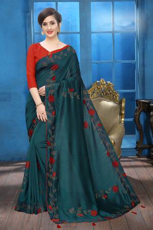 Flaunt Your Rich And Elegant Taste Wearing This Lovely Designer Saree In Teal Blue Color Paired With Red Colored Blouse. This Saree And Blouse Are Silk Based Beautified With Velvet Rose Patch Work And Attractive Stone Work. Buy This Rich and Elegant Looking Saree For The Upcoming Festive And Wedding Season.