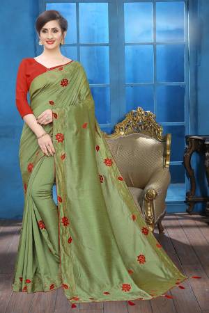 Flaunt Your Rich And Elegant Taste Wearing This Lovely Designer Saree In Light Olive Green Color Paired With Red Colored Blouse. This Saree And Blouse Are Silk Based Beautified With Velvet Rose Patch Work And Attractive Stone Work. Buy This Rich and Elegant Looking Saree For The Upcoming Festive And Wedding Season.