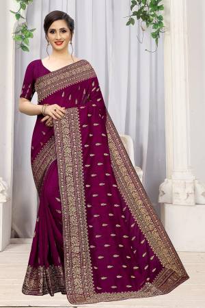 Add This Attractive Looking Designer Saree To Your Wardrobe For Upcoming Wedding And Festive Season. This Beautiful Saree Is In Wine Color Fabricated On Art Silk. It Is Beautified With Heavy Jari Embroidery And Stone Work. 