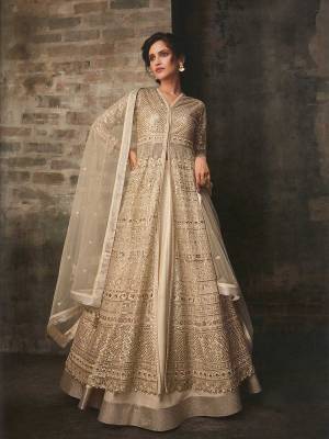 Flaunt Your Rich And Elegant Taste Wearing This Designer Indo-Western Suit In All Over Cream Color. Its Lovely Heavy Embroidered Top Is Fabricated On Net Paired With Art Silk Lehenga With A Satin Fabricated Bottom And Net Fabricated Dupatta. You Can Get Two Looks In One Dress As It Is Available With Two Bottoms. Buy Now.