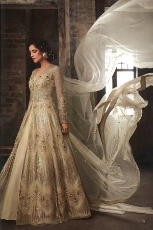 You Will Definitely Earn Lots Of Compliments Wearing This Designer Indo-Western Suit In Beige Color. Its Heavy Embroidered Top Is Fabricated On Net Paired With Art Silk Fabricated Lehenga And Net Fabricated Dupatta. Also It Comes With A Bottom Fabric In Satin Base, You can Get This Stitched As Pants Or Dhoti As Shown In Image. 