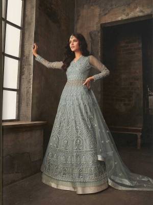 Flaunt Your Rich And Elegant Taste Wearing This Designer Indo-Western Suit In All Over Grey Color. Its Lovely Heavy Embroidered Top Is Fabricated On Net Paired With Art Silk Lehenga With A Santoon Fabricated Bottom And Net Fabricated Dupatta. You Can Get Two Looks In One Dress As It Is Available With Two Bottoms. Buy Now.