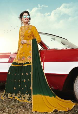 Celebrate This Festive Season With Beauty And Comfort Wearing This Heavy Designer Sharara Suit In Musturd Yellow Colored Top Paired With Contrasting Dark Green Colored Bottom And Dupatta. Its Top Is Satin Based Paired With Georgette Fabricated Bottom And Dupatta. Its Top And Bottom Are Beautified With Pretty Contrasting Embroidery. 