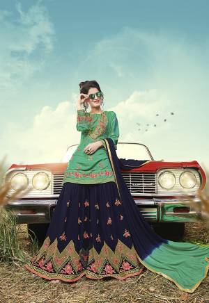 Here Is A Designer Trending Sharara Suit In Sea Green Colored Top Paired With Contrasting Navy Blue Colored Bottom And Dupatta. Its Top Is Fabricated On Satin Paired With Georgette Fabricated Bottom And Dupatta. It IS Beautified With Attractive Resham and Jari Embroidery with Stone Work. 