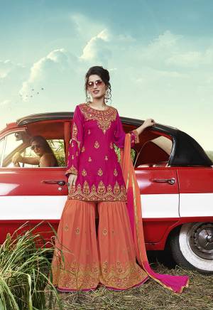 Celebrate This Festive Season With Beauty And Comfort Wearing This Heavy Designer Sharara Suit In Rani Pink Colored Top Paired With Contrasting Orange Colored Bottom And Dupatta. Its Top Is Satin Based Paired With Georgette Fabricated Bottom And Dupatta. Its Top And Bottom Are Beautified With Pretty Contrasting Embroidery. 