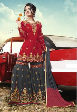 You Will Definitely Earn Lots Of Compliments In This Lovely Heavy Designer Sharara Suit In Red Colored Top Paired With Contrasting Dark Grey Colored Bottom And Dupatta. Its Embroidered Top Is Fabricated On Satin Paired With Embroidered Georgette Fabricated Bottom And Georgette Dupatta. 