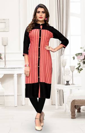 Here Is A Pretty Readymade Kurti For Your Casual Wear In Pink And Black Color. It Is Fabricated On Rayon Beautified With Prints. You can Pair This Up With Same Or Contrasting Colored Attire. Buy Now.