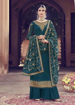 New Shade Is Here To Add Into Your Wardrobe With This Heavy Designer Straight Suit In Teal Blue Color. Its Top And Dupatta Are Fabricated on Georgette Beautified With Heavy Embroidery Paired With Santoon Bottom. 