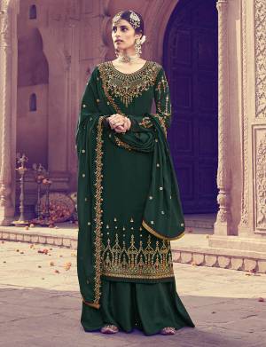 Beautiful Shade Is Here To Add Into Your Wardrobe With This Heavy Designer Straight Suit In Dark Green Color. Its Top And Dupatta Are Fabricated on Georgette Beautified With Heavy Embroidery Paired With Santoon Bottom. 