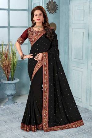 Here Is A Very Pretty Kashmiri Embroidered Designer Saree In Black Color. This Pretty Saree And Blouse Are Silk Based With Heavy Embroidered Multi Colored Thread Embroidery With Stone Work.
