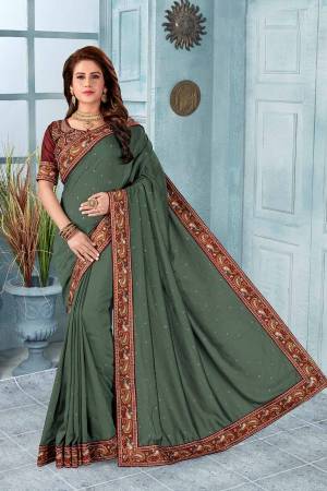 Grab This Heavy Embroidered Saree In Teal Green Color. This Saree?And Blouse Are Silk Based Beautified With Multi Colored Kashmiri Embroidery. This Pretty Saree Gives A Rich Look And It Is Suitable For Wedding And Festive Season. Buy Now.