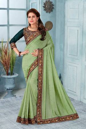 Here Is A Very Pretty Kashmiri Embroidered Designer Saree In Light Green Color. This Pretty Saree And Blouse Are Silk Based With Heavy Embroidered Multi Colored Thread Embroidery With Stone Work.