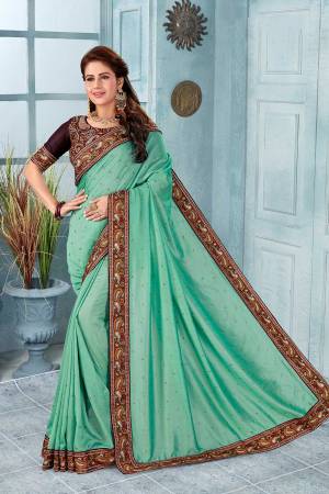 Here Is A Very Pretty Kashmiri Embroidered Designer Saree In Sea Green Color. This Pretty Saree And Blouse Are Silk Based With Heavy Embroidered Multi Colored Thread Embroidery With Stone Work.