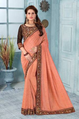 Grab This Heavy Embroidered Saree In Dark Peach Color. This Saree?And Blouse Are Silk Based Beautified With Multi Colored Kashmiri Embroidery. This Pretty Saree Gives A Rich Look And It Is Suitable For Wedding And Festive Season. Buy Now.