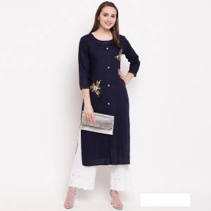For Your Semi-Casual Wear, Grab This Readymade Straight Cut Kurti In Navy Blue Color Fabricated On Rayon. It Is Beautified With Simple Resham Embroidery And Available In All Sizes. Buy Now.