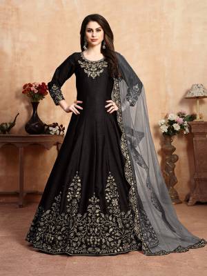 Here Is A Very Beautiful Heavy Designer Floor Length Suit In Black Color Paired With Grey Colored Dupatta. Its Top Is Fabricated On Art Silk Paired With Santoon Bottom And Net Fabricated Dupatta. It Has Heavy Embroidered Neck Line And Panel, Also With An Attractive Cut Work Dupatta.Buy Now.