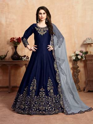Here Is A Very Beautiful Heavy Designer Floor Length Suit In Navy Blue Color Paired With Baby Blue Colored Dupatta. Its Top Is Fabricated On Art Silk Paired With Santoon Bottom And Net Fabricated Dupatta. It Has Heavy Embroidered Neck Line And Panel, Also With An Attractive Cut Work Dupatta.Buy Now.