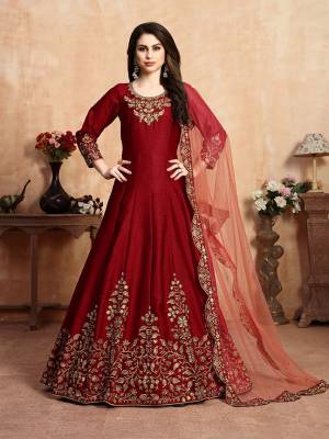 Here Is A Very Beautiful Heavy Designer Floor Length Suit In Red Color Paired With Dark Peach Colored Dupatta. Its Top Is Fabricated On Art Silk Paired With Santoon Bottom And Net Fabricated Dupatta. It Has Heavy Embroidered Neck Line And Panel, Also With An Attractive Cut Work Dupatta.Buy Now.