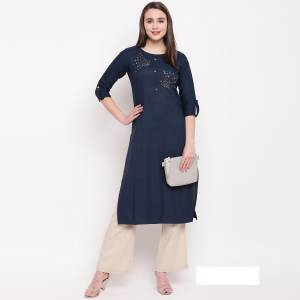 Enhance Your Personality Wearing This Designer Readymade Straight Kurti In Navy Blue Color Fabricated On Rayon. It Has Very Pretty Elegant Hand Work Over The Yoke. 