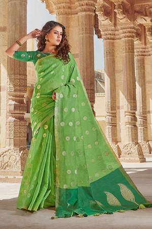 Celebrate This Festive Season With Beauty And Comfort Wearing This Elegant Looking Saree In Light Green Color Paired With Green Colored Blouse. This Saree And Blouse Are Fabricated On Linen Cotton Beautified With Weave. Buy Now.