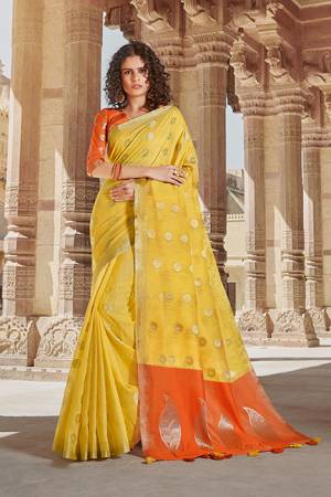 Rich and Elegant Looking Saree Is Here In Yellow Color Paired With Contrasting Orange Colored Blouse. This Saree And Blouse are Linen Cotton Based Beautified With Minimal Weave. 