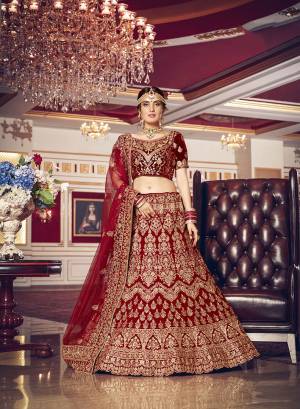 Get Ready For Your D-Day With This Heavy Designer Lehenga Choli In Maroon Color. This Heavy Embroidered Lehenga Choli Is Fabricated On Velvet Paired With Net Fabricated Dupatta. It Is Beautified With Heavy Jari Embroidery And Stone Work. Buy This Bridal Lehenga Now