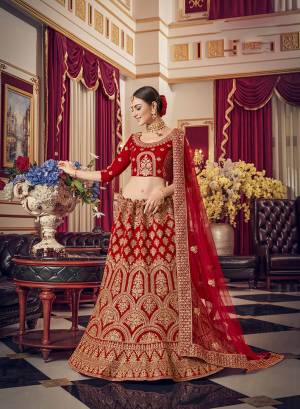 Get Ready For Your D-Day With This Heavy Designer Lehenga Choli In Red Color. This Heavy Embroidered Lehenga Choli Is Fabricated On Satin Paired With Net Fabricated Dupatta. It Is Beautified With Heavy Jari Embroidery And Stone Work. Buy This Bridal Lehenga Now