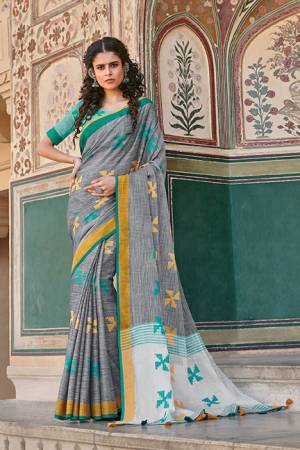 Flaunt Your Rich And Elegant Taste Wearing This Saree In Grey Color Paired With Contrasting Turquoise Blue Colored Blouse. This Saree And Blouse Are Fabricated On Linen Cotton Which Gives A Rich Look To Your Personality. 