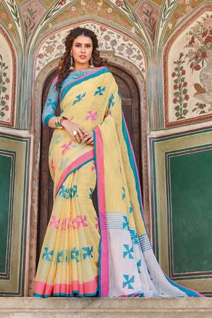 You Will Definitely Earn Lots Of Compliments Wearing This Pretty Saree In Light Yellow Color Paired With Contrasting Light Blue Colored Blouse. This Saree And Blouse Are Fabricated On Linen Cotton. It Is Light In Weight, Durable And Easy To Carry All Day Long. 