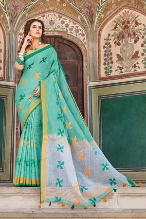 You Will Definitely Earn Lots Of Compliments Wearing This Pretty Saree In Sea Green Color Paired With Contrasting Light Yellow Colored Blouse. This Saree And Blouse Are Fabricated On Linen Cotton. It Is Light In Weight, Durable And Easy To Carry All Day Long. 