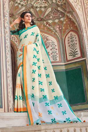 Flaunt Your Rich And Elegant Taste Wearing This Saree In Cream Color Paired With Contrasting Sea Green Colored Blouse. This Saree And Blouse Are Fabricated On Linen Cotton Which Gives A Rich Look To Your Personality. 