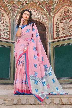 You Will Definitely Earn Lots Of Compliments Wearing This Pretty Saree In Light Pink Color Paired With Contrasting Blue Colored Blouse. This Saree And Blouse Are Fabricated On Linen Cotton. It Is Light In Weight, Durable And Easy To Carry All Day Long. 