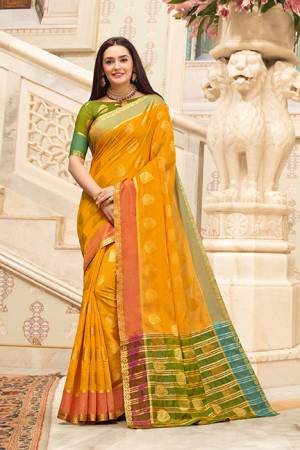 Celebrate This Festive Season With Beauty And Comfort Wearing This Pretty Saree In Musturd Yellow Color Paired With Contrasting Green Colored Blouse. This Saree And Blouse Are Fabricated on Cotton Handloom Beautified With Weave. Buy This Saree Now.