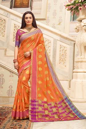 Celebrate This Festive Season With Beauty And Comfort Wearing This Pretty Saree In Orange Color Paired With Contrasting Magenta Pink Colored Blouse. This Saree And Blouse Are Fabricated on Cotton Handloom Beautified With Weave. Buy This Saree Now.