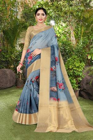 Flaunt Your Rich And Elegant Taste Wearing This Saree In Steel Blue Color Paired With Beige Colored Blouse. This Saree And Blouse Are Fabricated Linen Silk Beautified With Prints And Jacquard Border. 