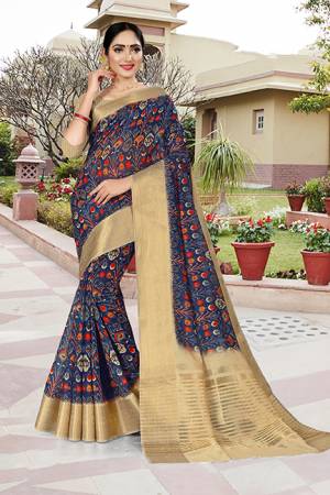Add This Pretty Saree to Your Wardrobe In Navy Blue Color Paired With Beige Colored Blouse. This Saree And Blouse Are Linen Silk Based Beautified With Prints And Jacquard Lace Border. 