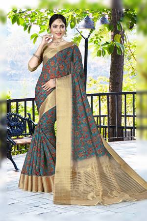 Add This Pretty Saree to Your Wardrobe In Dark Blue Color Paired With Beige Colored Blouse. This Saree And Blouse Are Linen Silk Based Beautified With Prints And Jacquard Lace Border. 