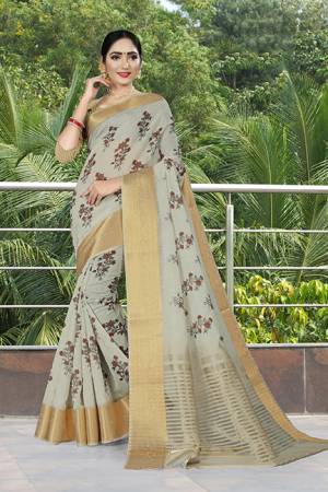 Add This Pretty Saree to Your Wardrobe In Light Grey Color Paired With Beige Colored Blouse. This Saree And Blouse Are Linen Silk Based Beautified With Prints And Jacquard Lace Border. 