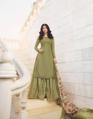 New Shade In Green Is Here To Add Into Your Wardrobe With This Heavy Designer Sharara Suit In Light Olive Green Color Paired With Light Pastel Green Colored Dupatta. Its Top And Bottom Are Fabricated On Muslin Georgette Paired With Jacquard Silk Fabricated Dupatta. Buy This Pretty Suit Now.