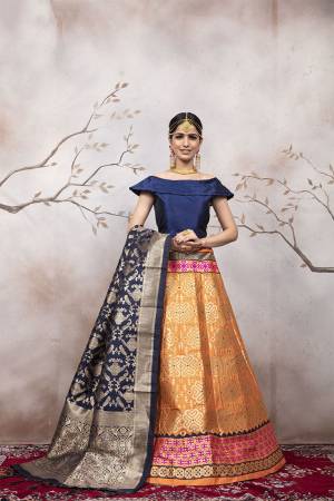 Here Is A Very Beautiful Silk Based Designer Lehenga Choli In Navy Blue Colored Blouse Paired With Orange Colored Lehenga And Navy Blue Colored Dupatta. This Lehenga Choli Is Silk based Giving A Rich And Elegant Llook To Your Personality.