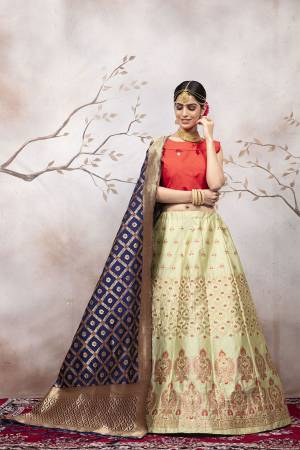 Go Colorful with Thid Very Designer Lehenga Choli In Orange Colored Blouse Paired With Pastel Green Colored Lehenga And Navy Blue Colored Dupatta. This Lehenga Choli And Dupatta Are Silk Based Beautified With Weave. Buy Now.