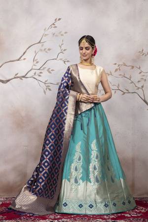 Add This Very Pretty Designer Lehenga Choli To Your Wardrobe In Cream Colored Blouse Paired With Blue Colored Lehenga And Navy Blue Colored Dupatta. This Lehenga Choli Is Silk Based Beautified With Attractive Weave. Buy Now.
