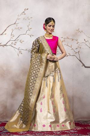 Here Is A Very Beautiful Silk Based Designer Lehenga Choli In Rani Pink Colored Blouse Paired With Cream Colored Lehenga And Grey Colored Dupatta. This Lehenga Choli Is Silk based Giving A Rich And Elegant Llook To Your Personality.
