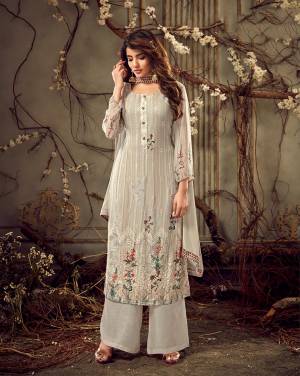Add This Lovely Designer Straight Suit To Your Wardrobe In Light Grey Color. Its Heavy Embroidered Top Is Fabricated On Georgette Paired With Santoon Bottom And Chiffon Fabricated Dupatta. It Is Beautified With Floral Prints, Tone To Tone Thread Embroidery and Stone Wok. 