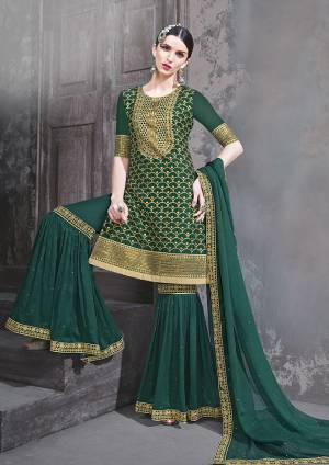 Get Ready For The Upcoming Festive And Wedding Season Wearing This Heavy Designer Sharara Suit In Pine Color. Its Top And Bottom Are Fabricated on Georgette Paired With Chiffon Fabricated Dupatta. Buy Now.