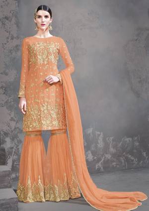 Celebrate This Festive Season With Beauty And Comfort Wearing This Heavy Designer Sharara Suit In Orange Color. Its Top Is Fabricated on Georgette Paired With Net Net Fabricated Bottom And Chiffon Dupatta. 