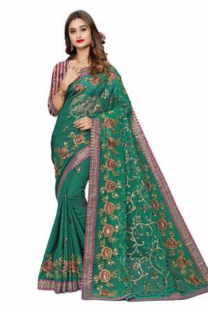 Here Is An Attractive Looking Designer Saree In Green Color. This Saree Is Fabricated On Jacquard Silk And Net Paired With Jacquard Silk Fabricated Blouse. Buy This Saree Now.